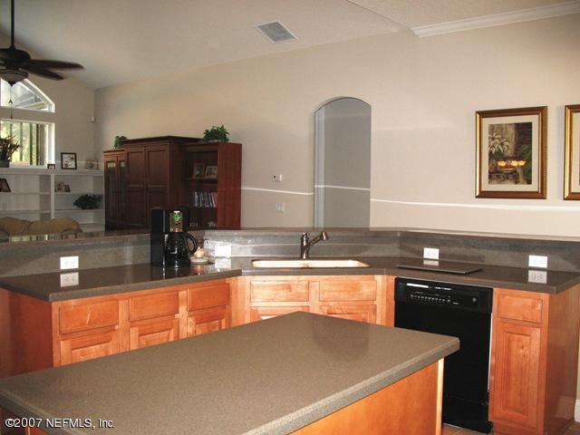 376 North Lombardy Loop Jacksonville, FL 32259 - Photo 10 of 24 a kitchen with granite countertop a sink and cabinets