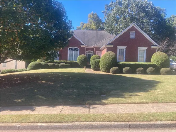 a front view of a house with garden