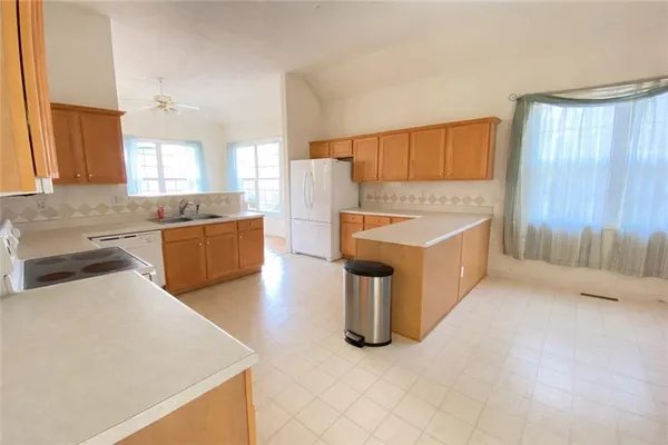 a kitchen with a sink stove and cabinets