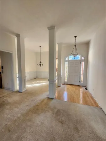 a view of a room with cabinet and chandelier