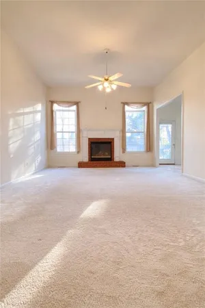 a view of livingroom with fireplace window and a kitchen