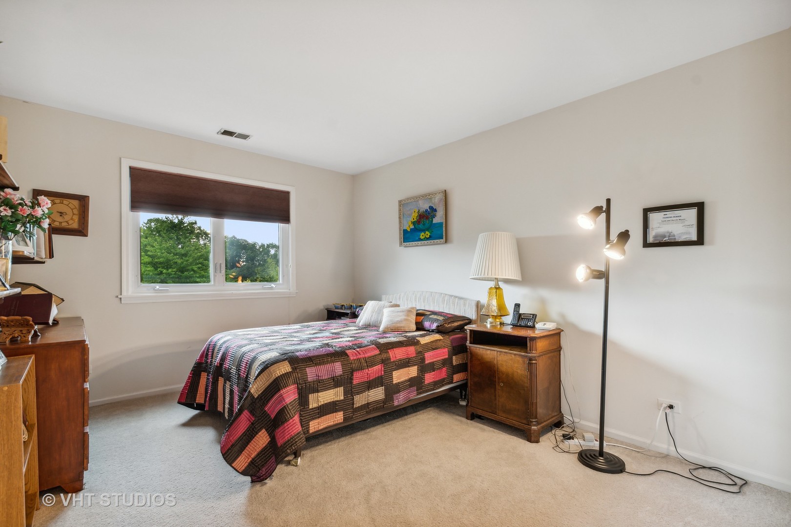 9801 Gross Point Road, Unit 308 Skokie, IL 60076 - Photo 12 of 16 a bedroom with a bed and a window