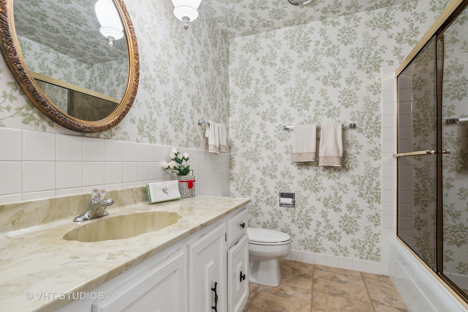 9801 Gross Point Road, Unit 308 Skokie, IL 60076 - Photo 13 of 16 a bathroom with a granite countertop sink a toilet and a mirror