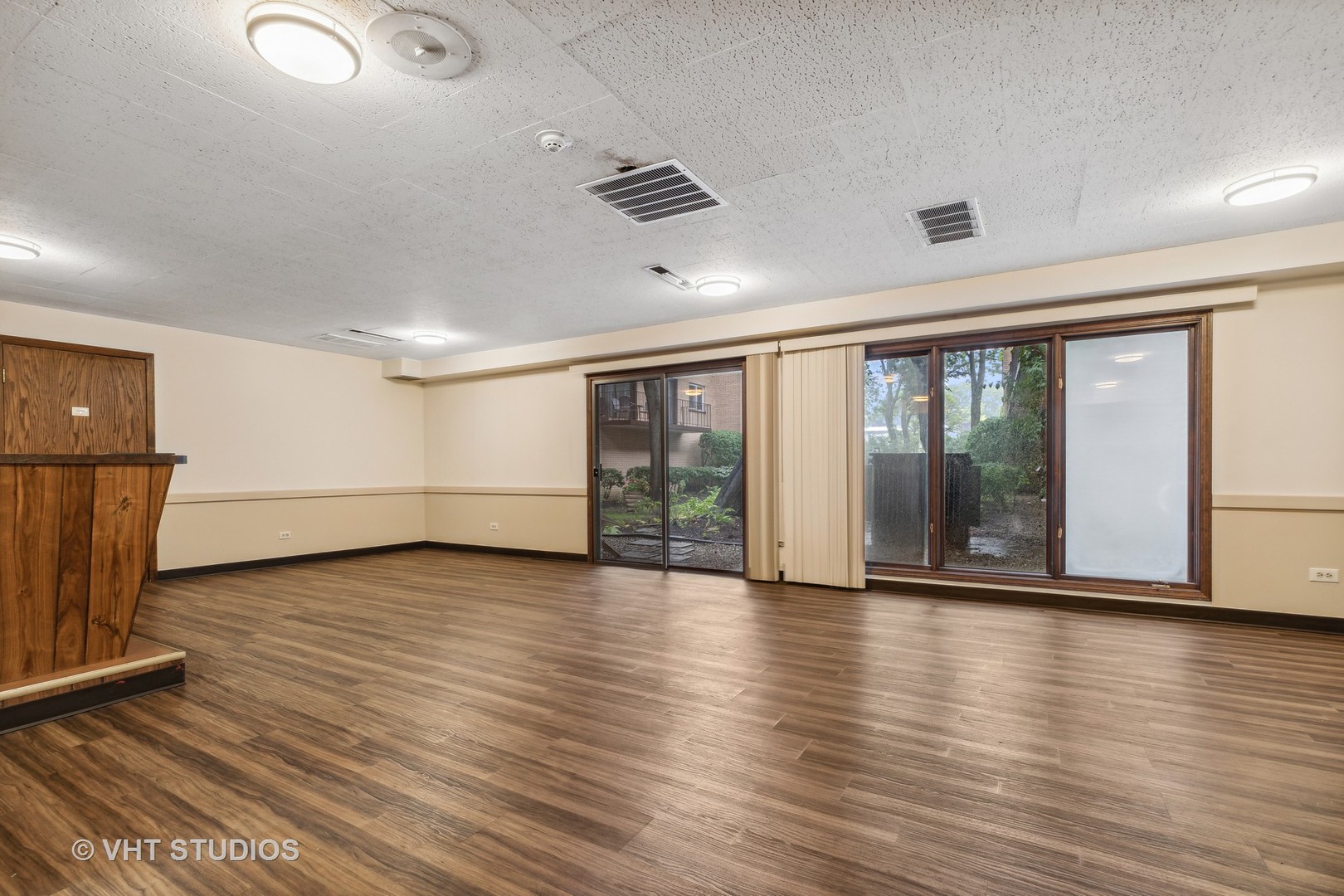 9801 Gross Point Road, Unit 308 Skokie, IL 60076 - Photo 15 of 16 an empty room with wooden floor and windows