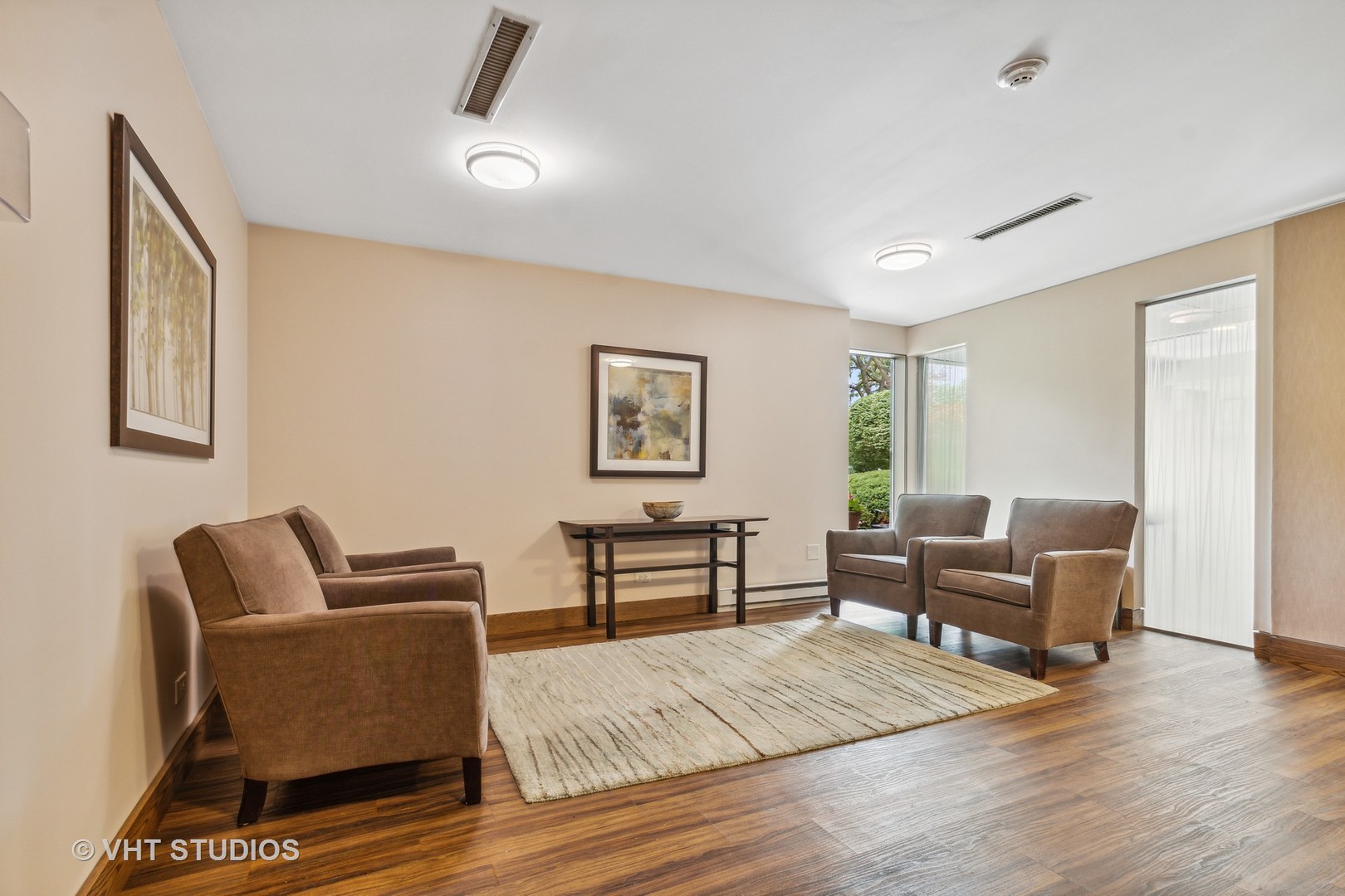 9801 Gross Point Road, Unit 308 Skokie, IL 60076 - Photo 2 of 16 a living room with furniture and a wooden floor