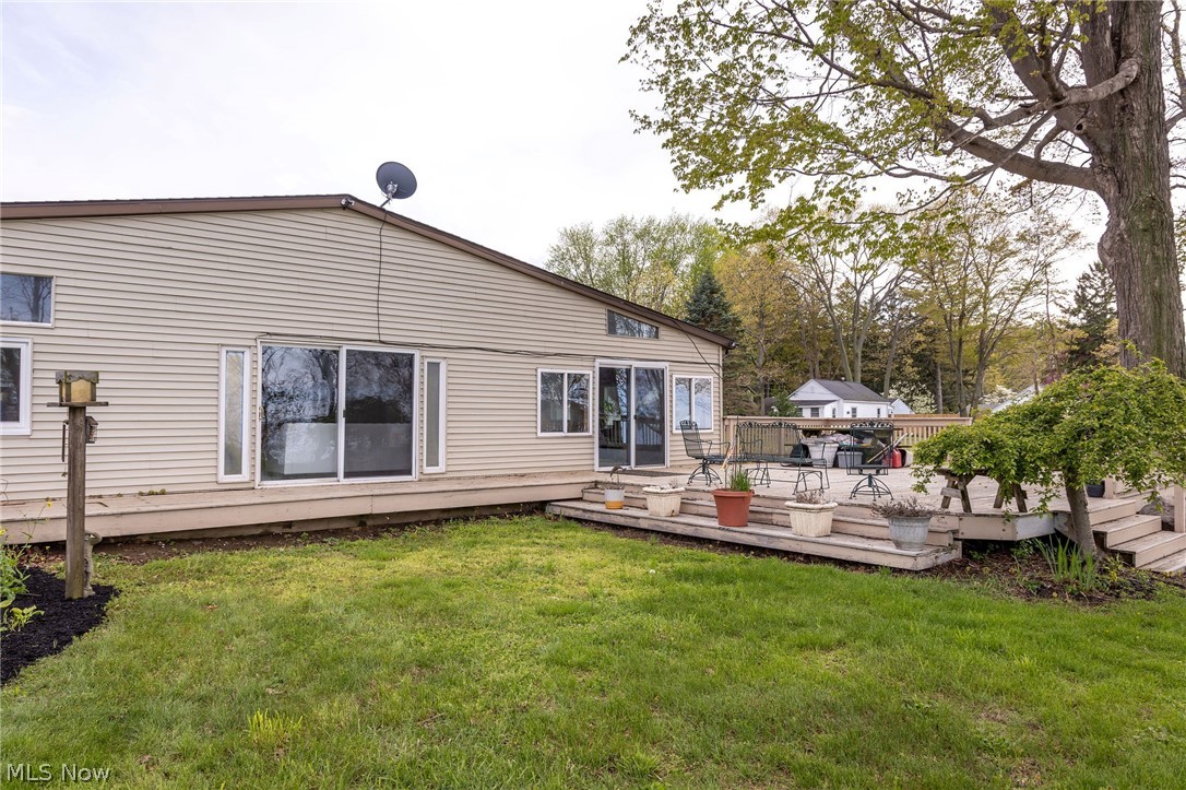 5467 Chapel Road Madison, OH 44057 - Photo 6 of 50 Spacious backyard featuring a multi-level wood deck, expansive lawn, and mature trees