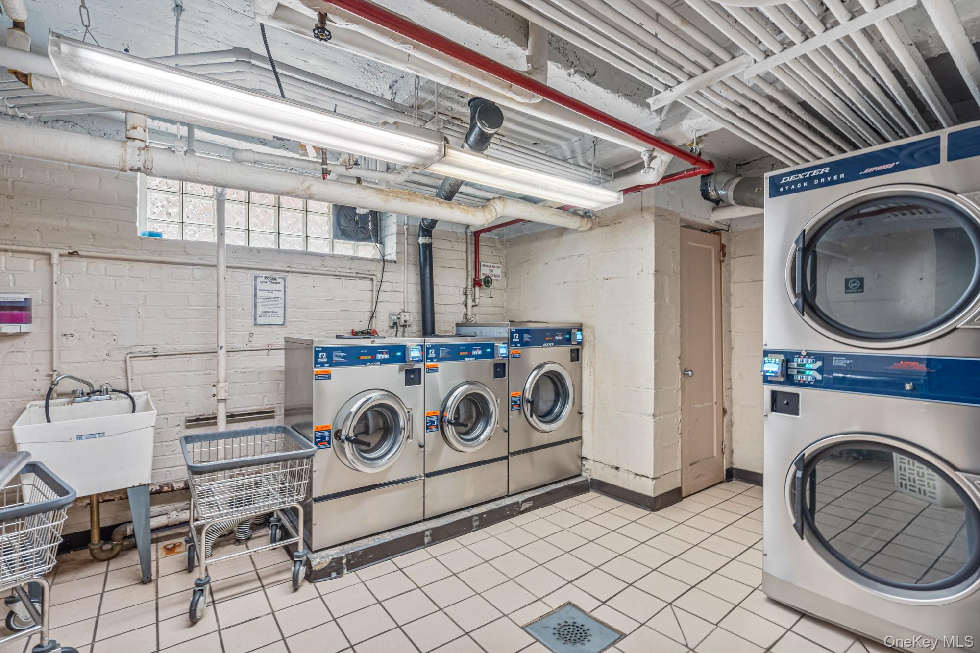 102-55 67th Road, Unit 2V Queens, NY 11375 - Photo 12 of 14 a utility room with dryer and washer
