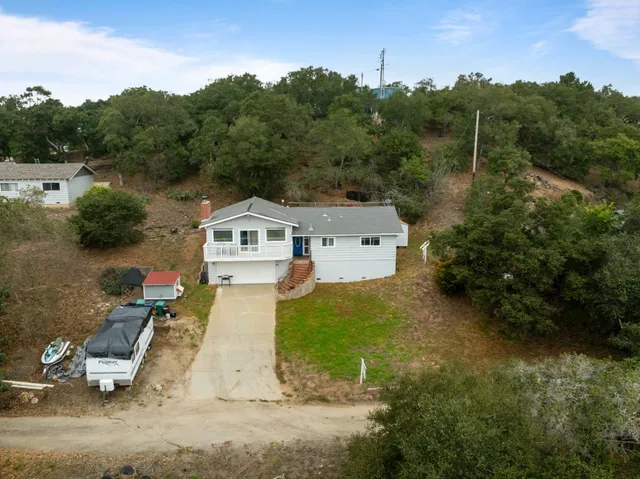 an aerial view of a house with a yard