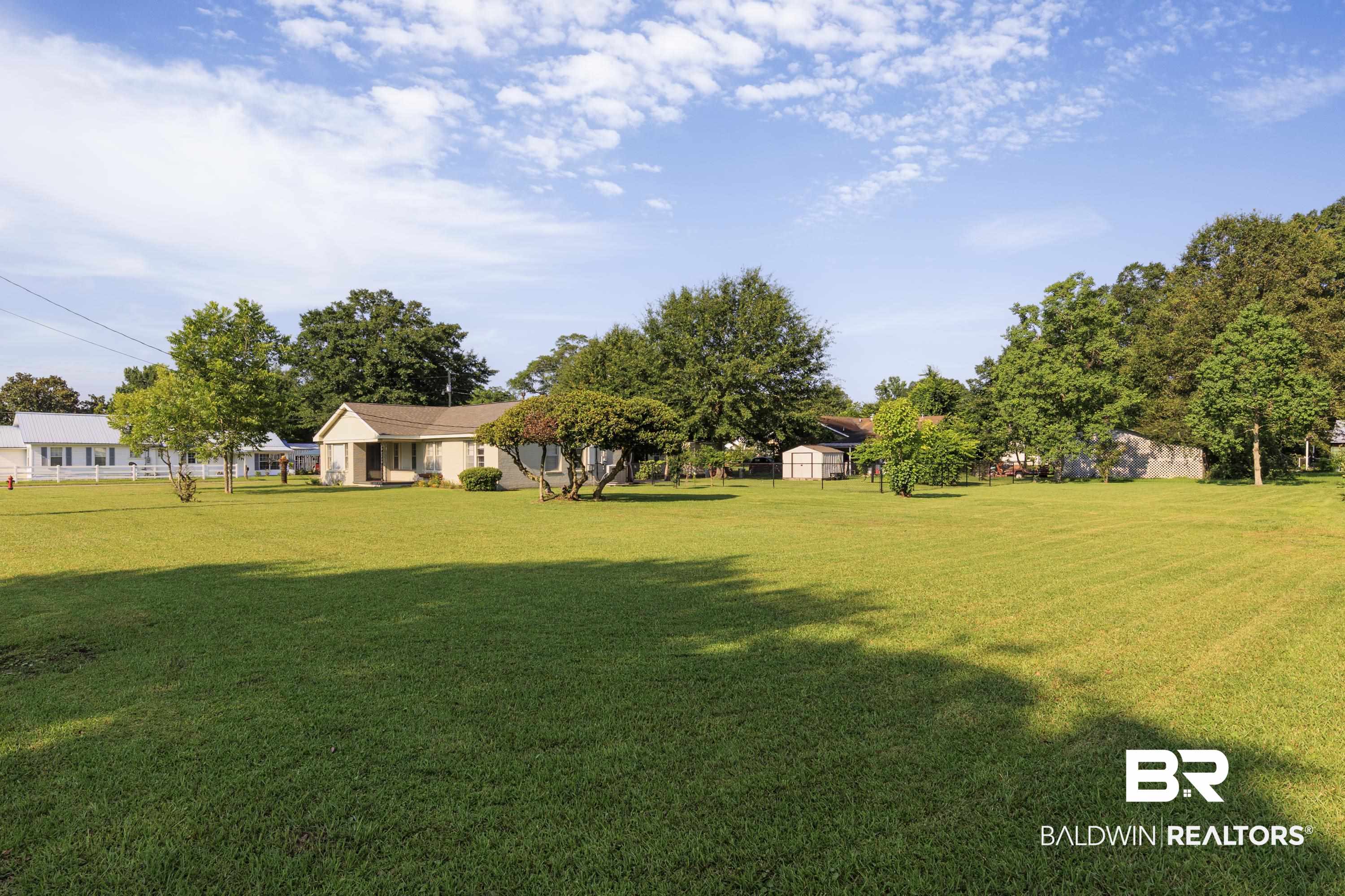 208 Beck Street Atmore, AL 36502 - Photo 2 of 26 View of grassy yard featuring a storage unit