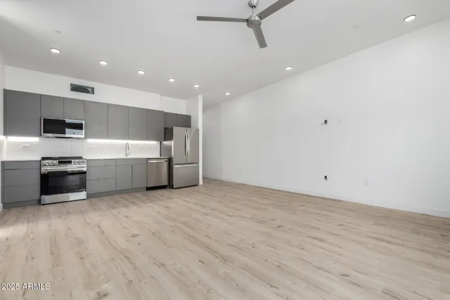 a view of a kitchen with a sink and a stove top oven