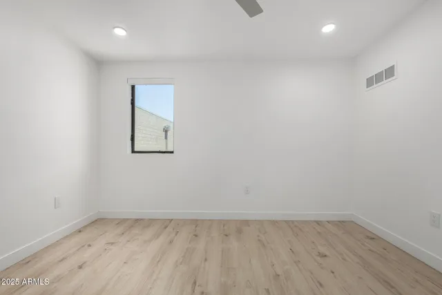 a view of an empty room and wooden floor