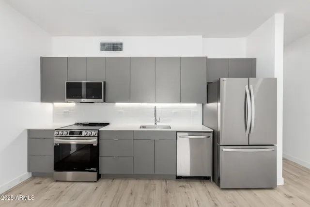 a kitchen with a sink a stove and refrigerator
