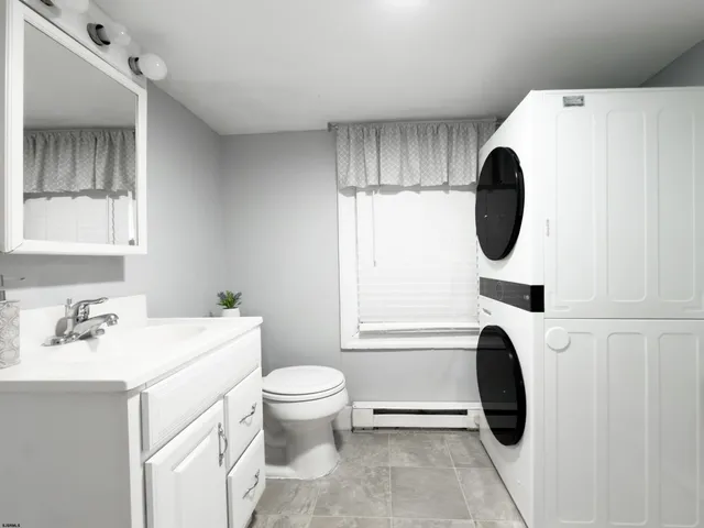 a bathroom with a sink a toilet and a mirror
