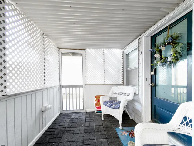 a balcony with furniture and a potted plant