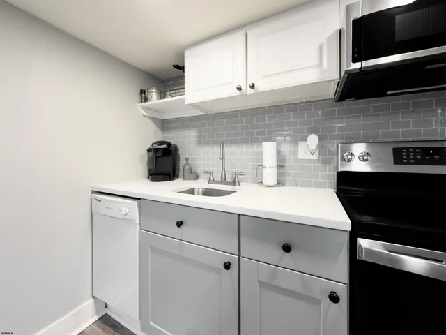 a kitchen with a sink and cabinets
