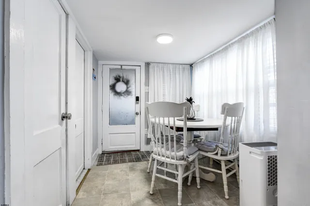 a dining room with furniture and window