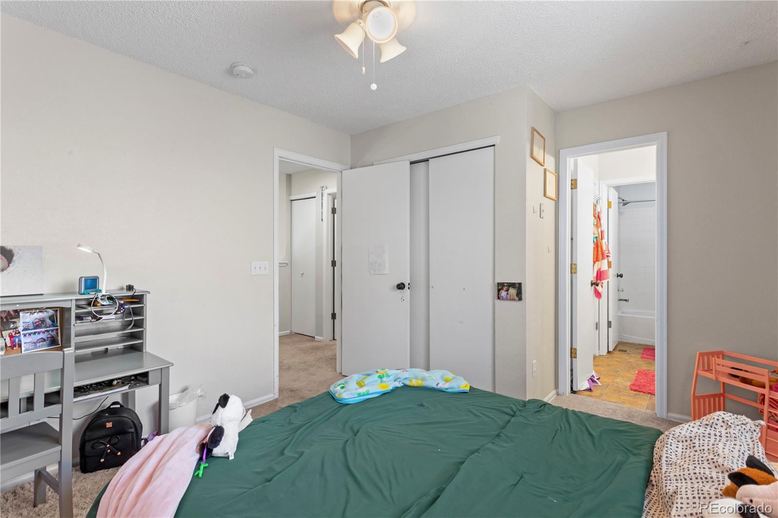 2212 Hyacinth Road Littleton, CO 80129 - Photo 30 of 44 a bedroom with a bed and a window