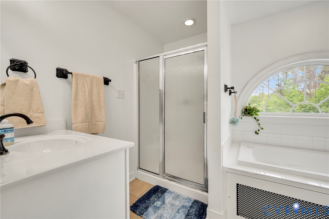 3090 Poor House Road Goochland, VA 23063 - Photo 23 of 32 Bathroom featuring a built-in tub with an arched w
