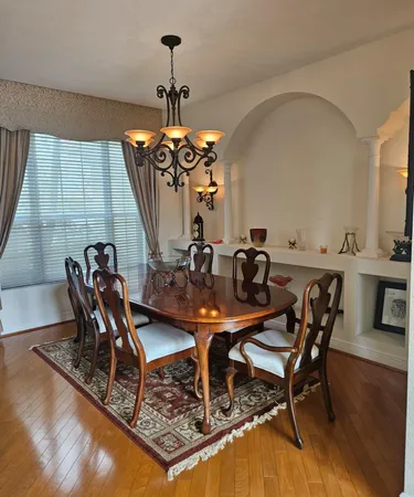 a kitchen with granite countertop a stove top oven a sink dishwasher and a refrigerator with wooden floor