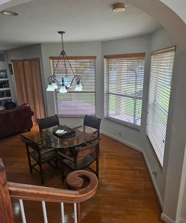 a dining room with furniture and window