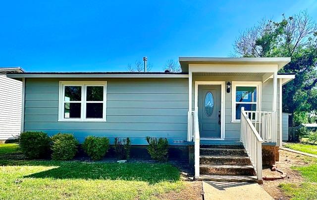 903 North 4th Street Ballinger, TX 76821 - Photo 1 of 12 a front view of a house with a yard