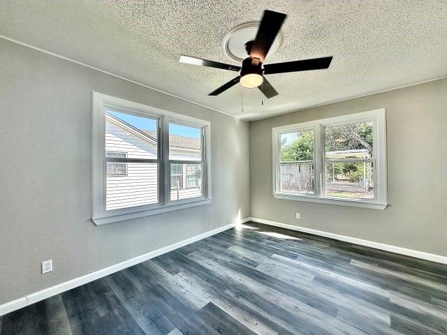 903 North 4th Street Ballinger, TX 76821 - Photo 11 of 12 a view of an empty room with wooden floor and a window