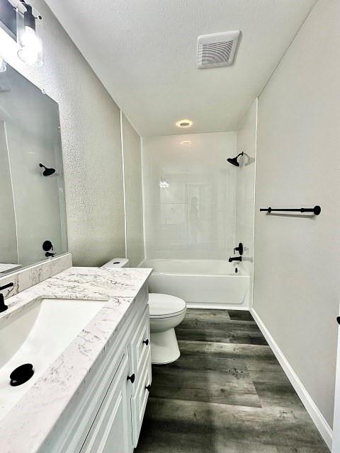 903 North 4th Street Ballinger, TX 76821 - Photo 12 of 12 a bathroom with a granite countertop sink a toilet and shower