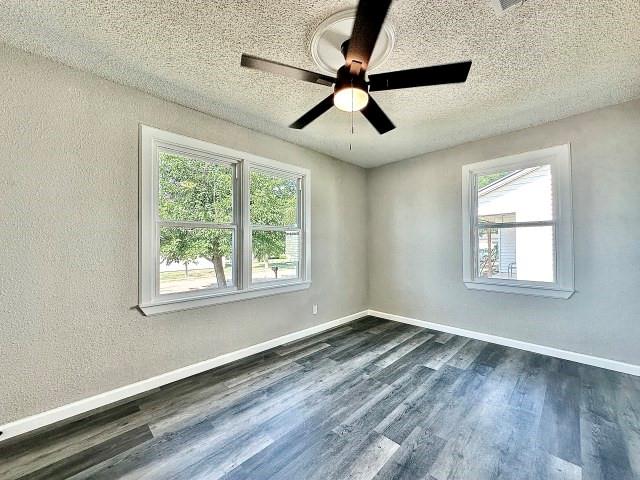 903 North 4th Street Ballinger, TX 76821 - Photo 10 of 12 a view of a room with wooden floor and windows