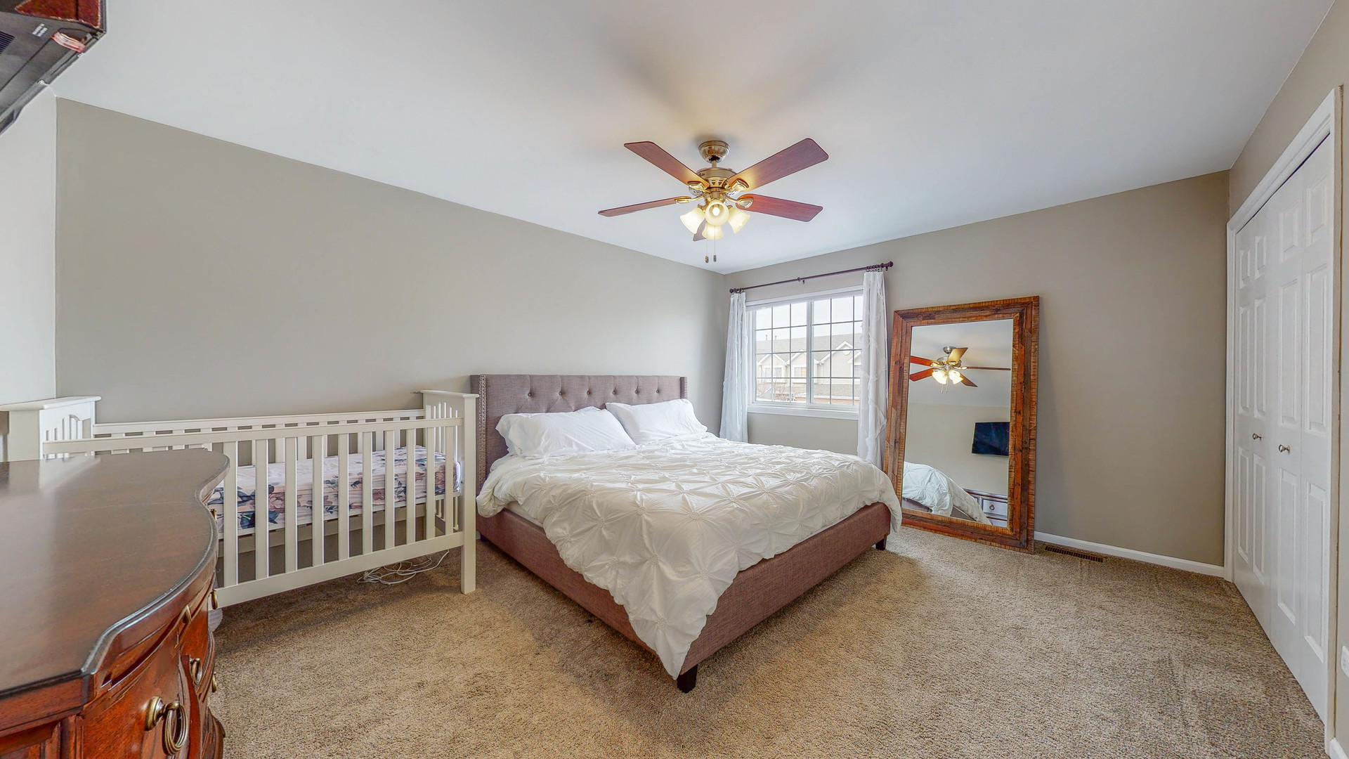 16031 Golf View Drive Lockport, IL 60441 - Photo 13 of 23 a bedroom with a bed and a chandelier