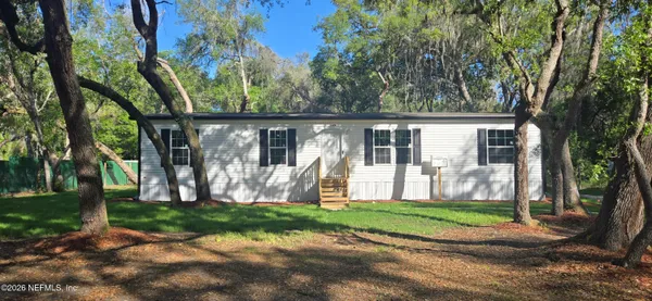 a view of a house with backyard from a tree