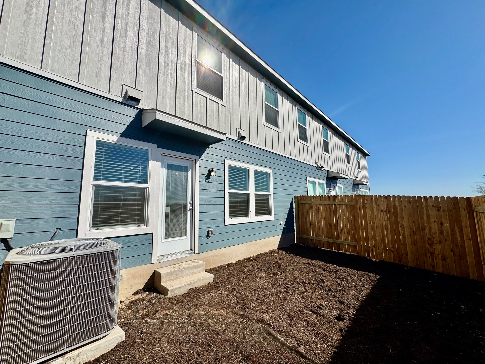 104 Calcite Road, Unit 3 Kyle, TX 78640 - Photo 5 of 7 Rear view of house with board and batten siding