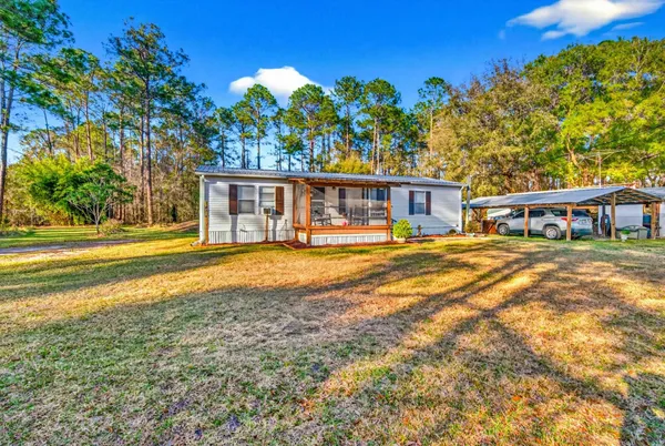 a dining room with furniture a flat screen tv and a painting