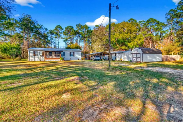 a bathroom with a sink a toilet and shower curtain