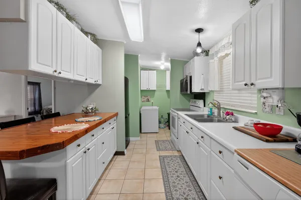 a backyard of a house with barbeque oven table and chairs
