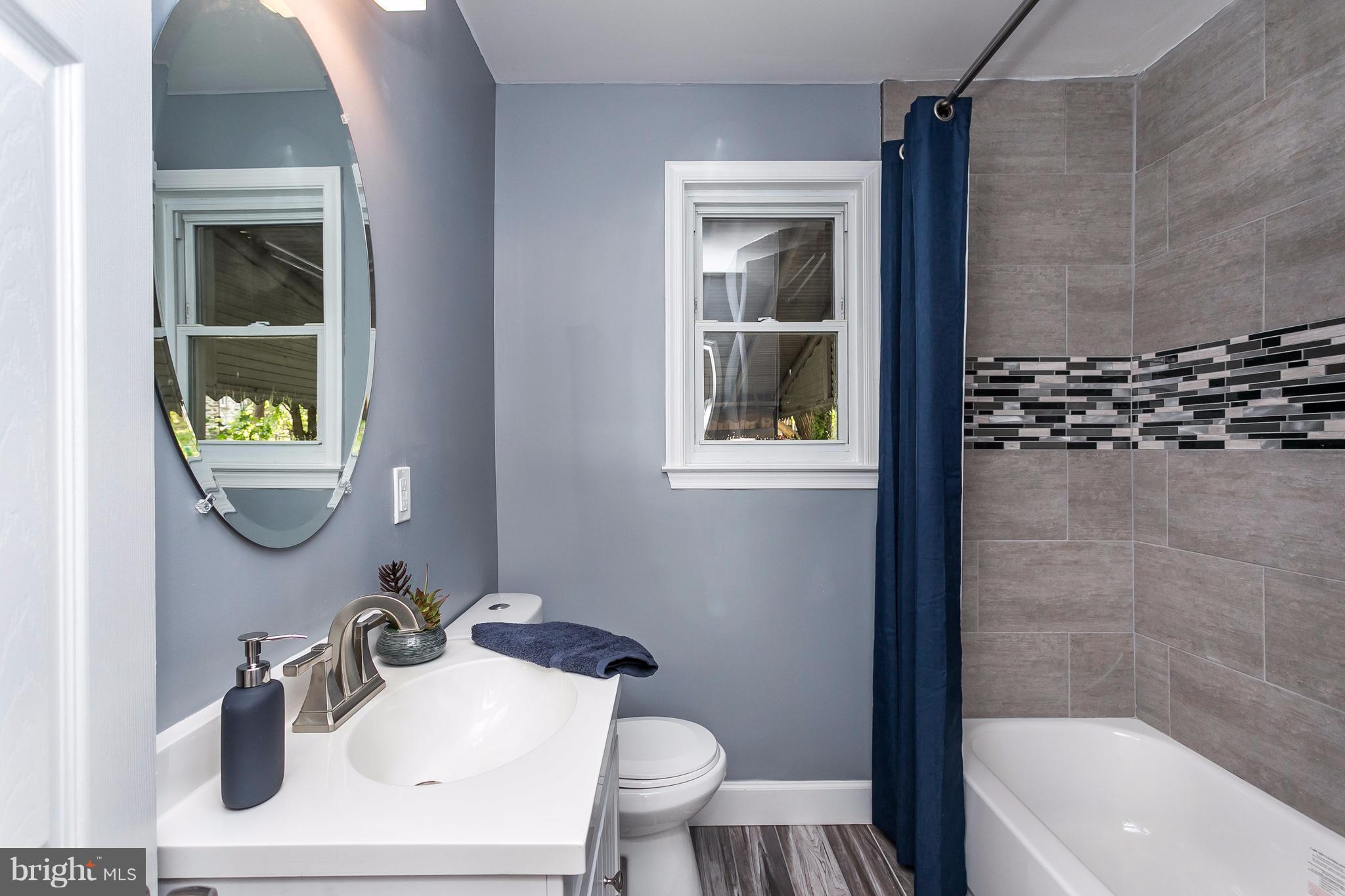 3203 Cedarhurst Road Baltimore, MD 21214 - Photo 14 of 29 a bathroom with a sink toilet and shower