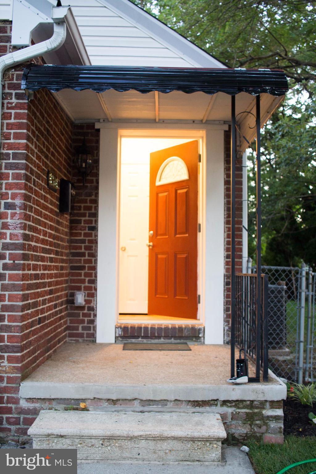 3203 Cedarhurst Road Baltimore, MD 21214 - Photo 3 of 29 a front view of a house with a yard