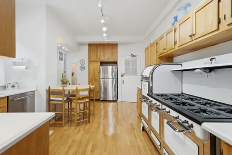 a kitchen with stainless steel appliances granite countertop a stove and a refrigerator