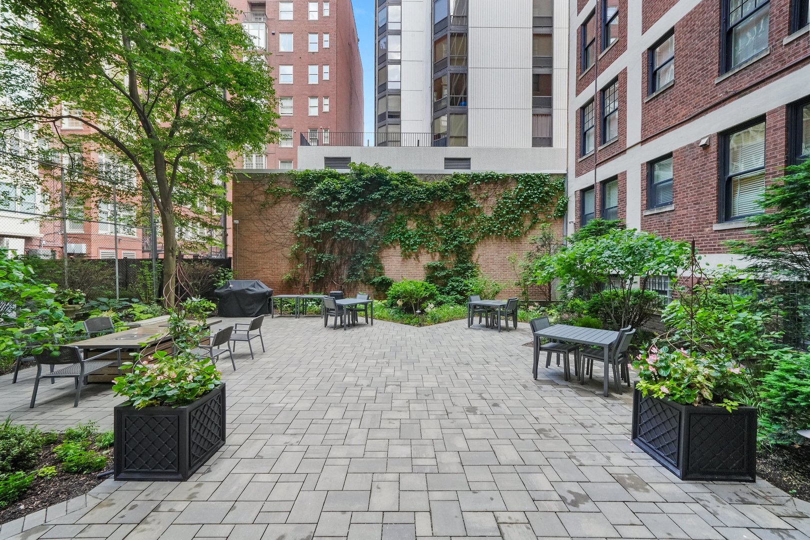 232 East Walton Place, Unit 3E Chicago, IL 60611 - Photo 33 of 36 a view of a patio with plants and chairs