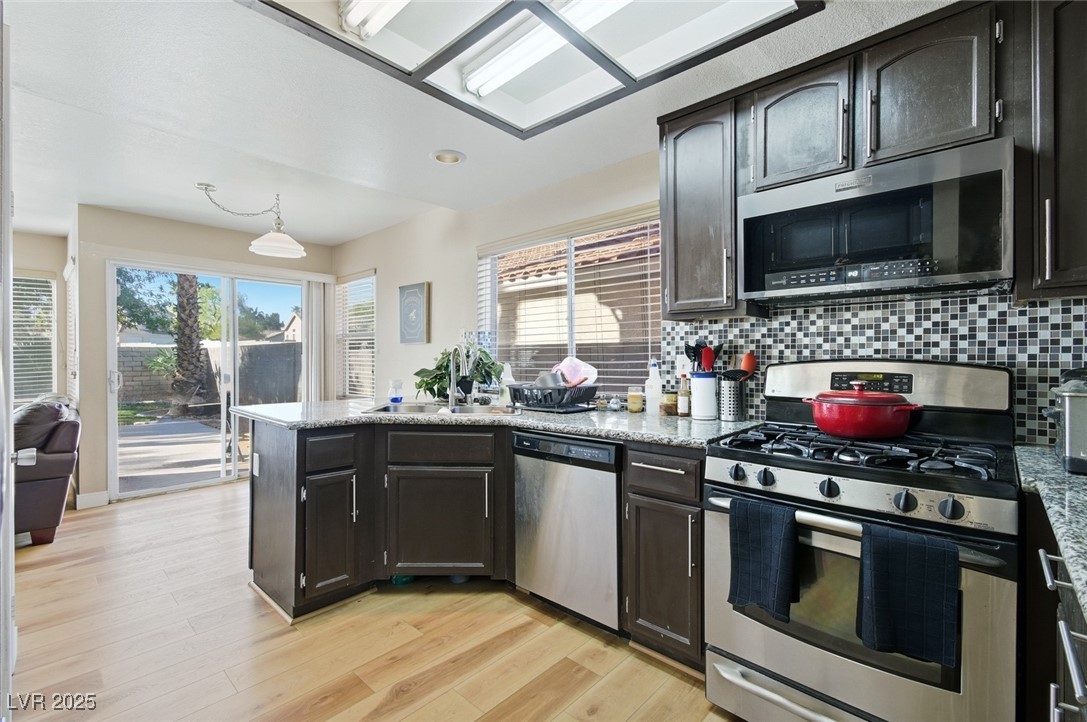 8623 Tiverton Road Las Vegas, NV 89123 - Photo 4 of 18 KITCHEN WITH GRANITE COUNTERS, LOTS OF CABINET SPACE, EAT IN NOOK AND BACKYARD ACCESS