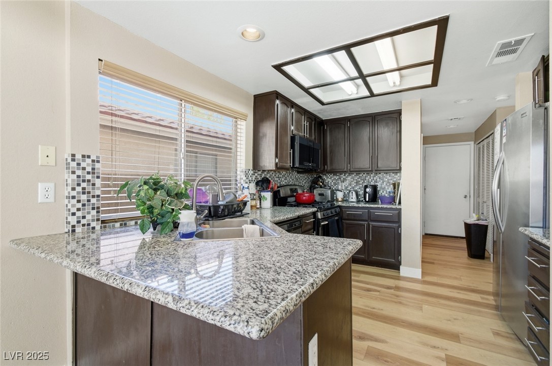 8623 Tiverton Road Las Vegas, NV 89123 - Photo 5 of 18 KITCHEN HAS BREAKFAST BAR AND CUSTOM BACKSPLASH