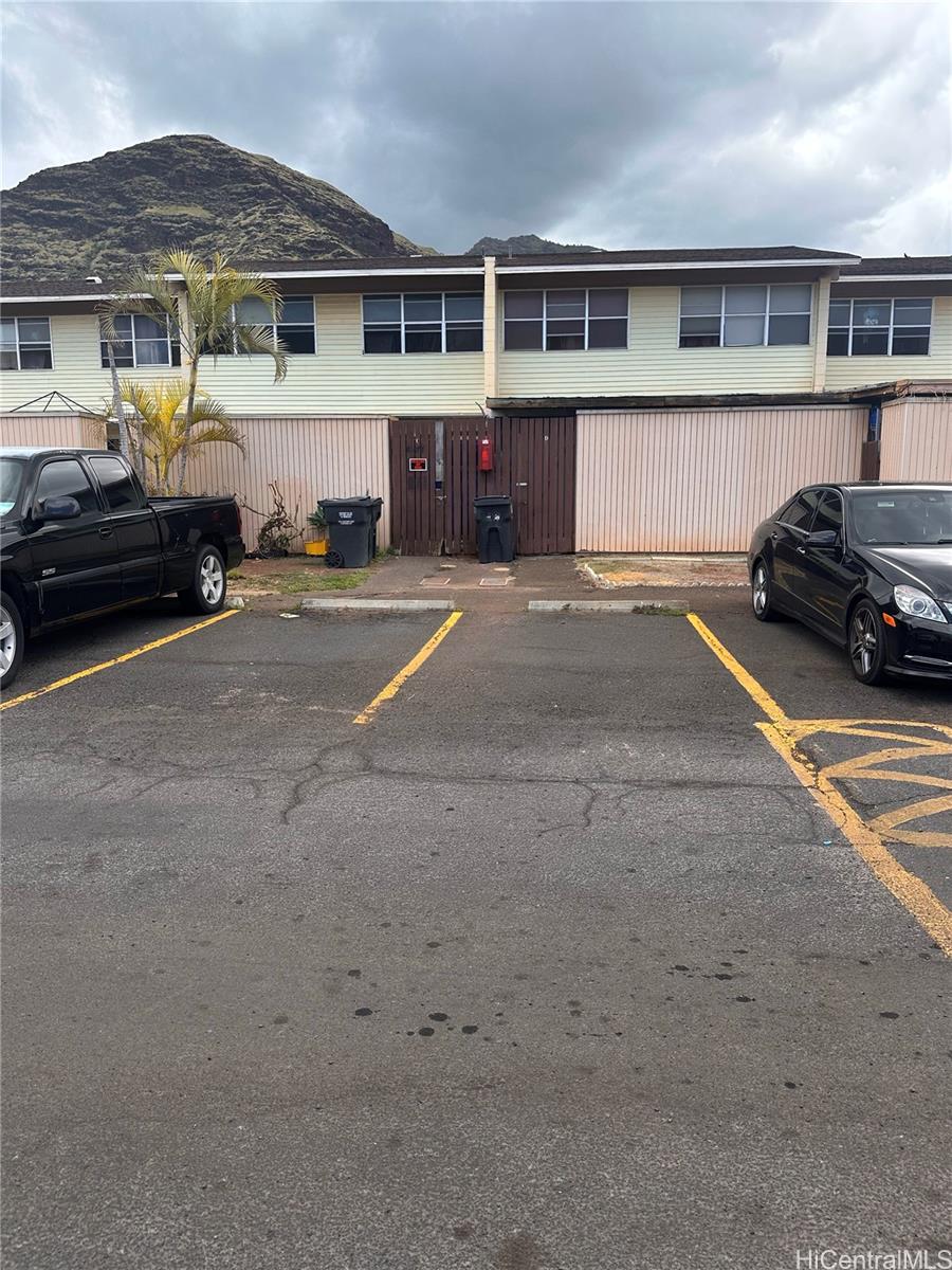 a front view of a house with a parking space