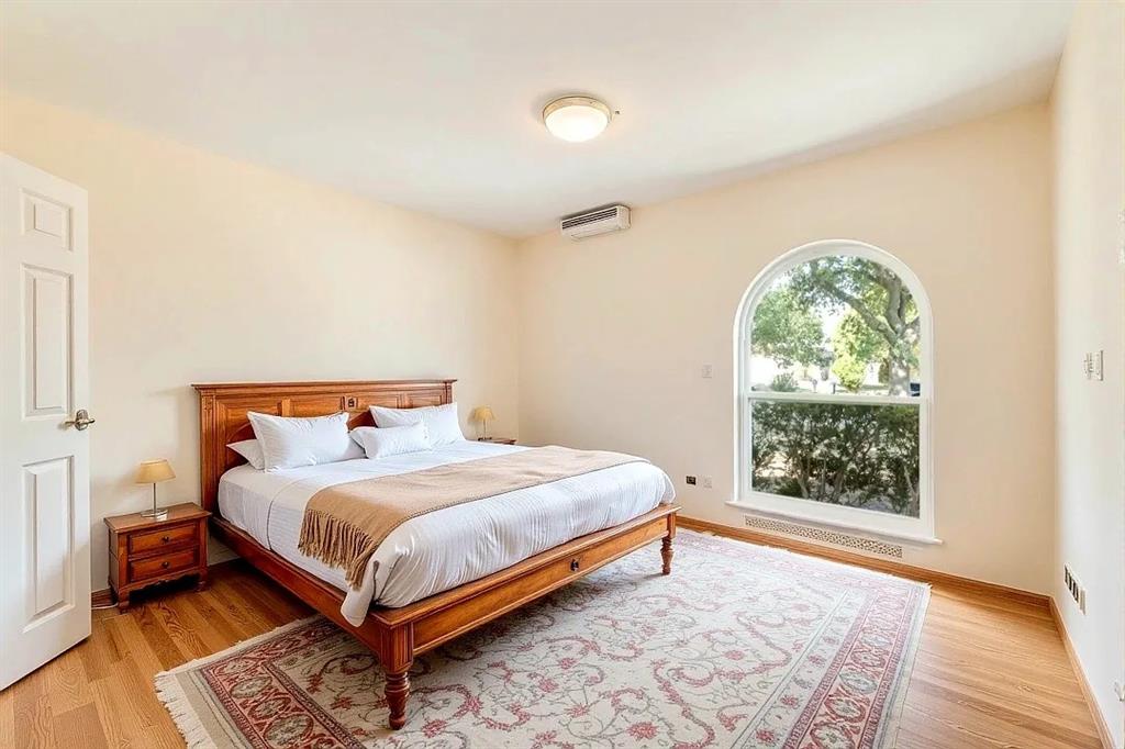 9324 County View Road Dallas, TX 75249 - Photo 13 of 24 a bedroom with a bed and window