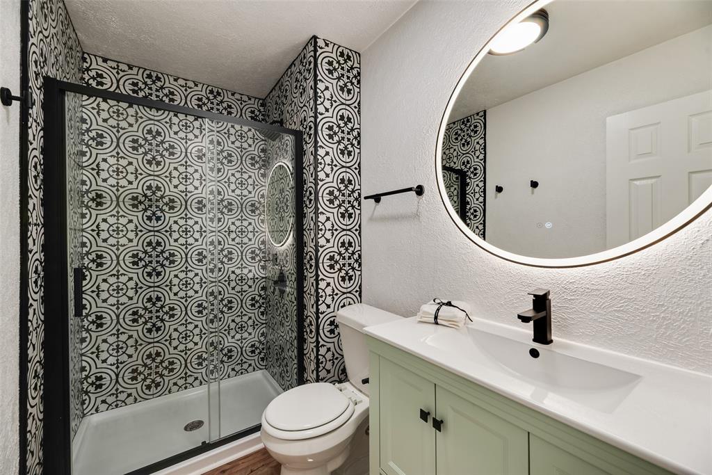 9324 County View Road Dallas, TX 75249 - Photo 15 of 24 a bathroom with a sink toilet and shower