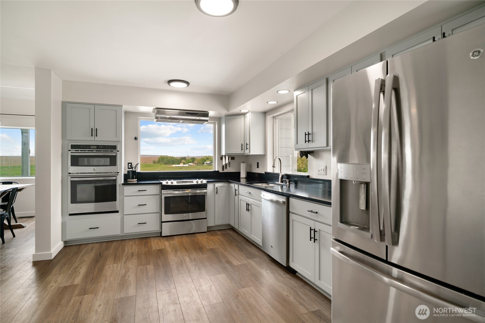 11975 Northeast Neppel Road Moses Lake, WA 98837 - Photo 17 of 33 a kitchen with stainless steel appliances a stove sink and refrigerator