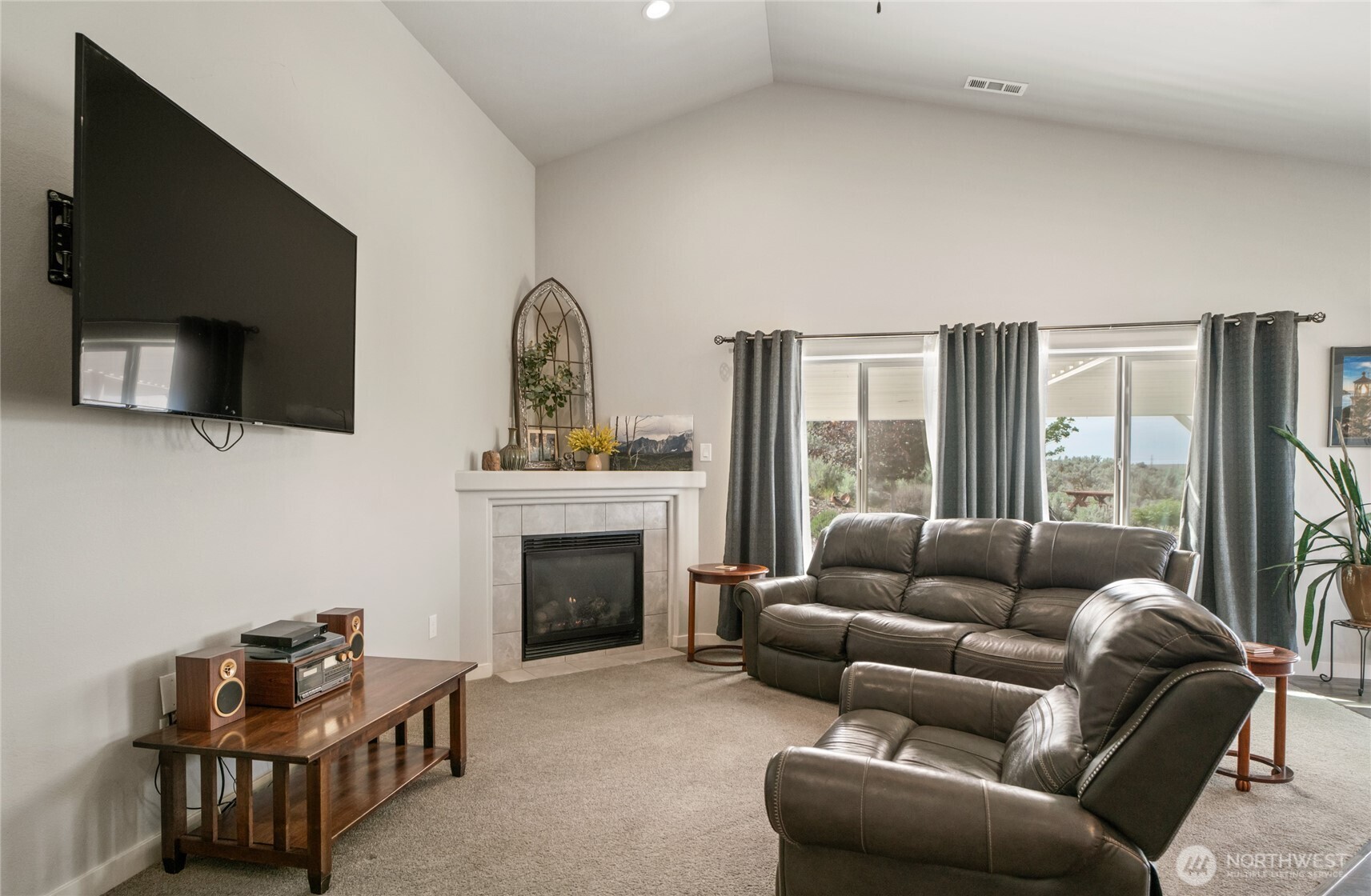 11975 Northeast Neppel Road Moses Lake, WA 98837 - Photo 7 of 33 a living room with furniture a flat screen tv and a fireplace