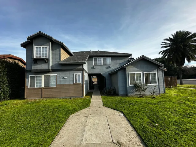a front view of house with yard and green space