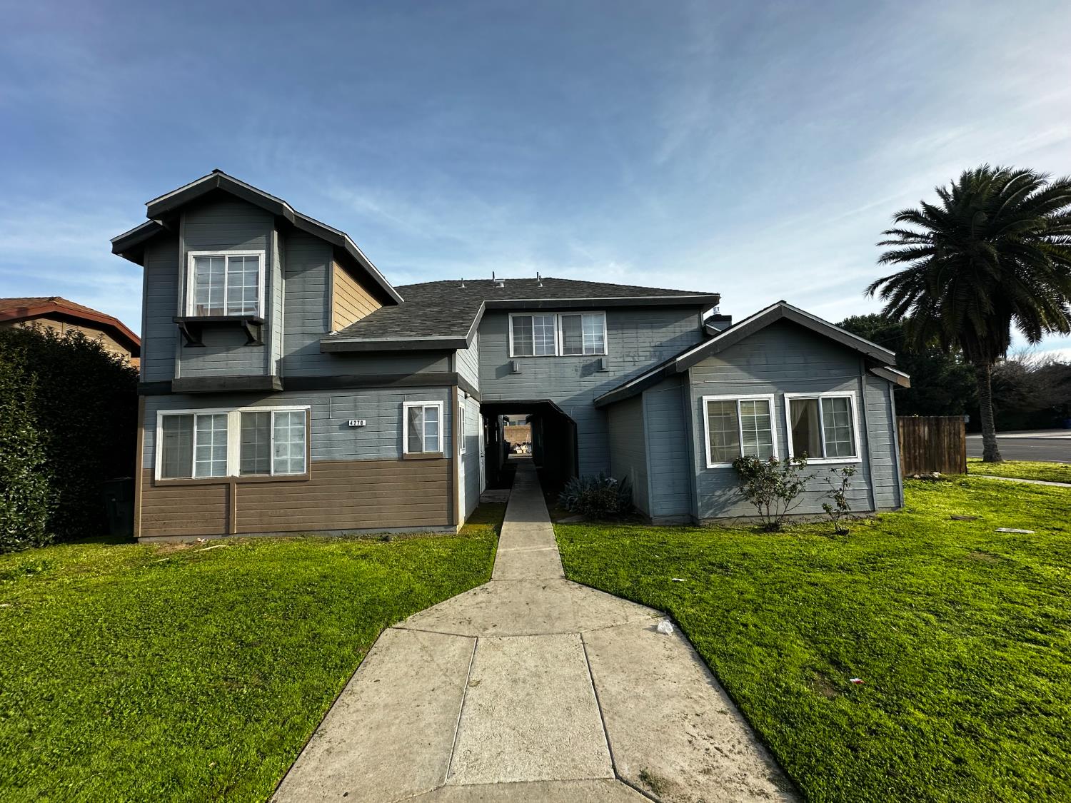 4270 West Regency Avenue Fresno, CA 93722 - Photo 1 of 6 a front view of house with yard and green space