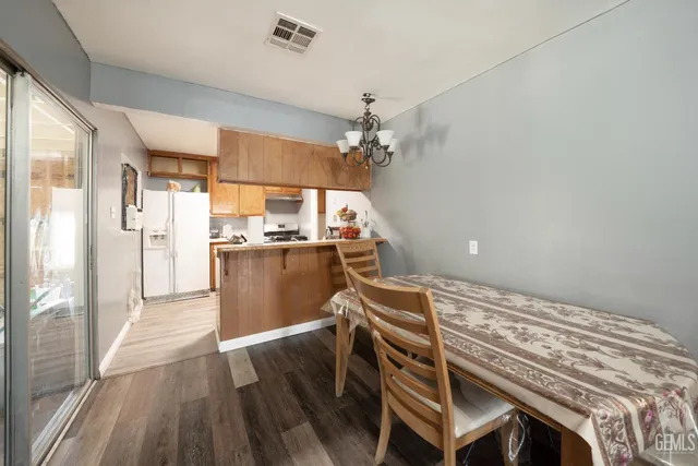 a view of a kitchen with kitchen island a sink stainless steel appliances and cabinets