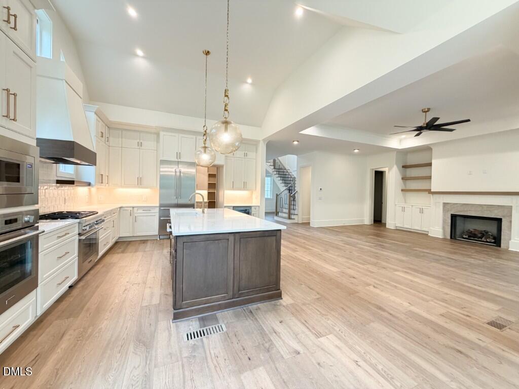 7441 Summer Tanager Trail Raleigh, NC 27614 - Photo 4 of 48 a large kitchen with kitchen island a sink stainless steel appliances and cabinets