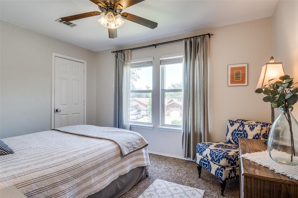 4018 Cedar Elm Lane Dallas, TX 75212 - Photo 15 of 22 a bedroom with a bed and a chandelier